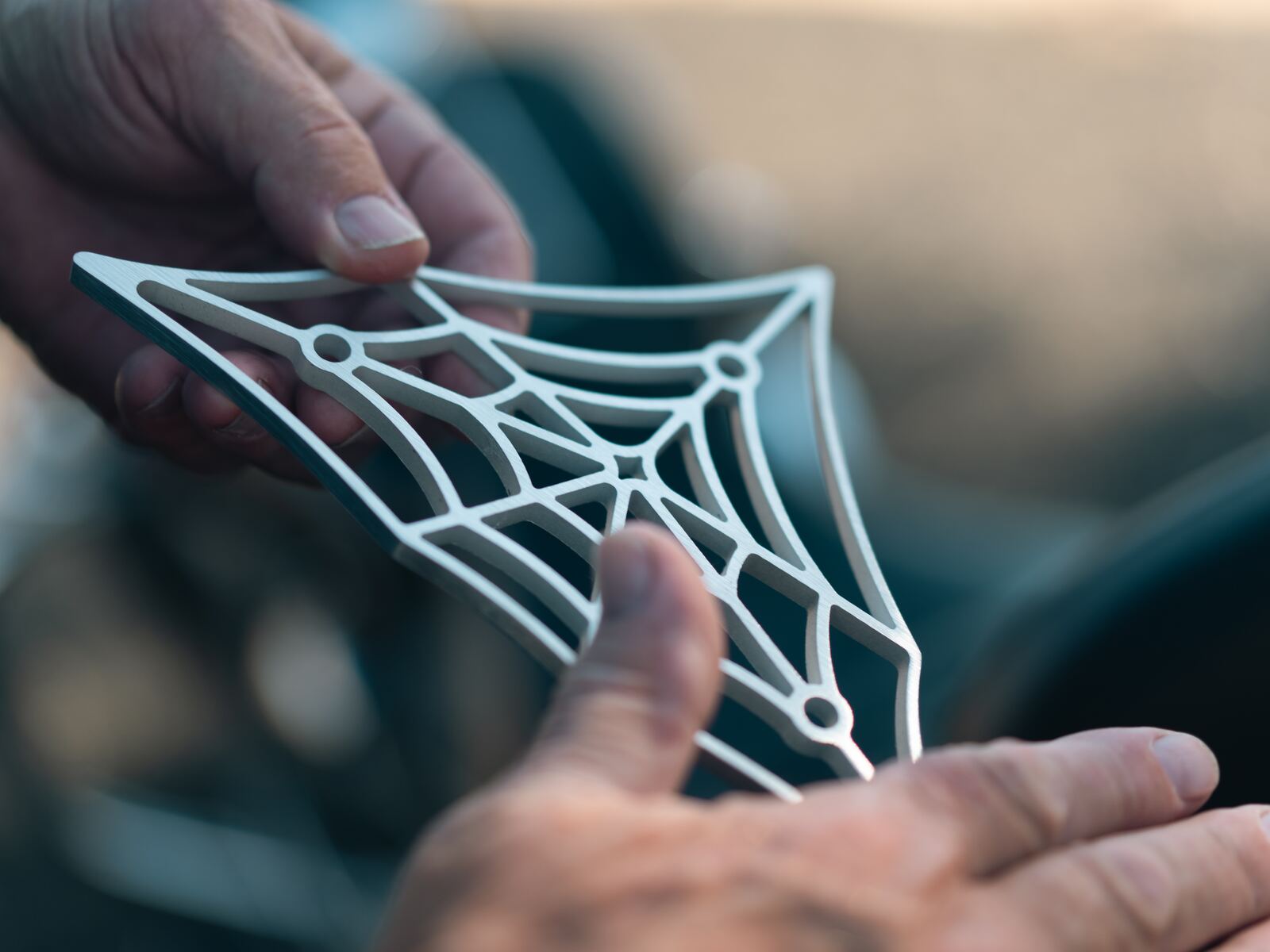 Brushed aluminum web in hand