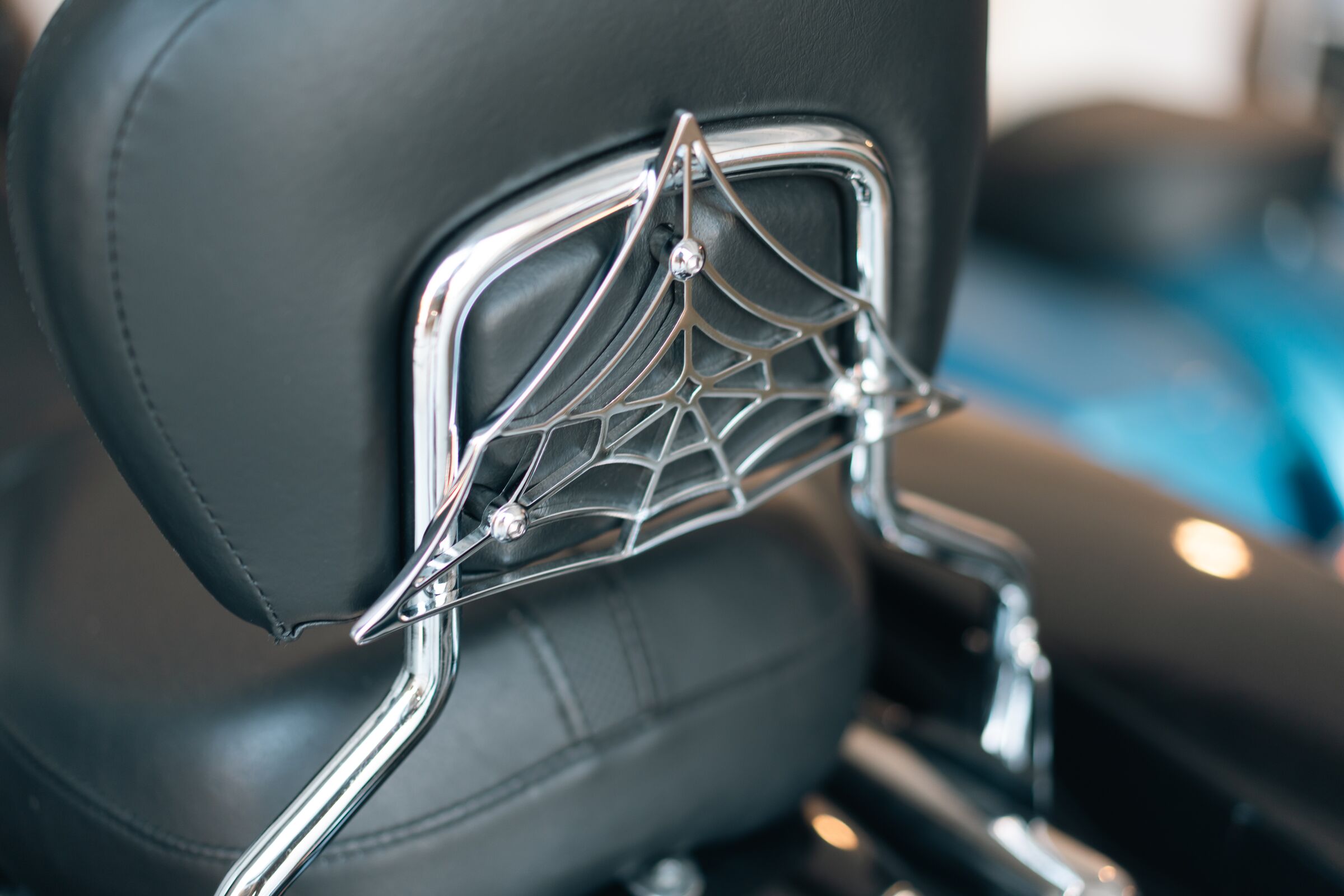 The Black Widow chrome spider-web sissy bar on a Harley Touring backrest
